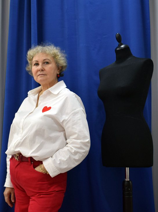 Lyubov Borovskih beside a dress form in the atelier
